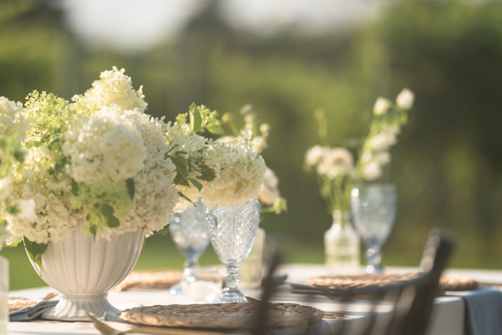 Elegant table setting with pastel floral decor and glassware at a Southern-inspired Atlanta wedding reception.