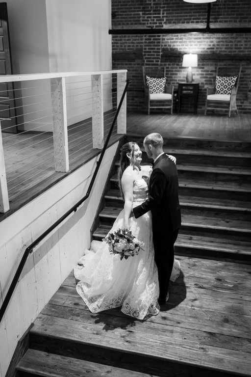 Bride and groom sharing a romantic moment on the stairs.