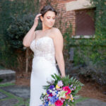 Bride with spring bouquet curving her hand to her face.