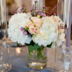 Elegant centerpiece with soft florals and candlelight at The Factory at Walton Mill wedding reception.