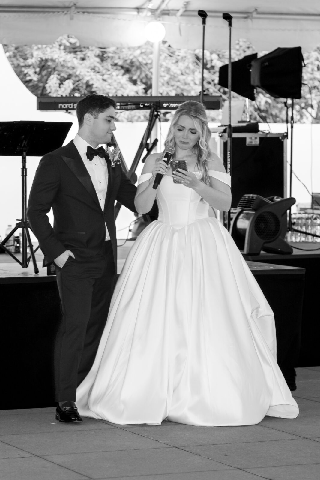The bride tears up while reading her speech, supported by the groom, during their wedding reception at The 173 Carlyle House.
