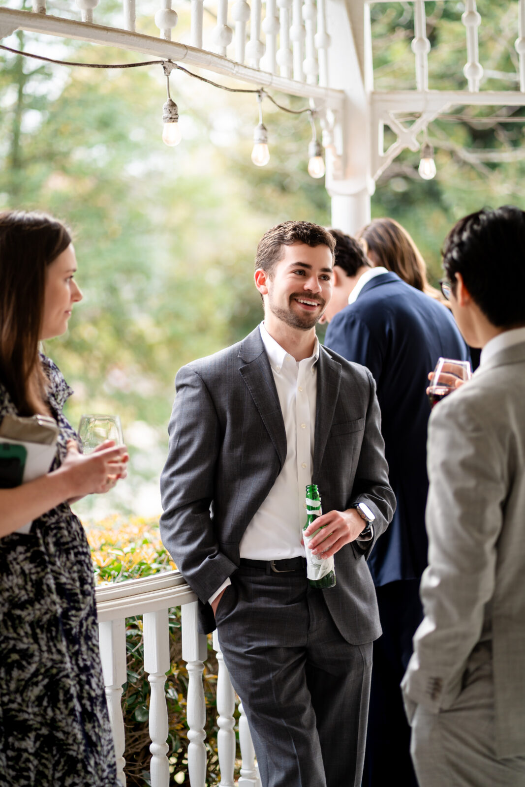 Wedding guests enjoying conversation on the veranda at 173 Carlyle House in Norcross GA