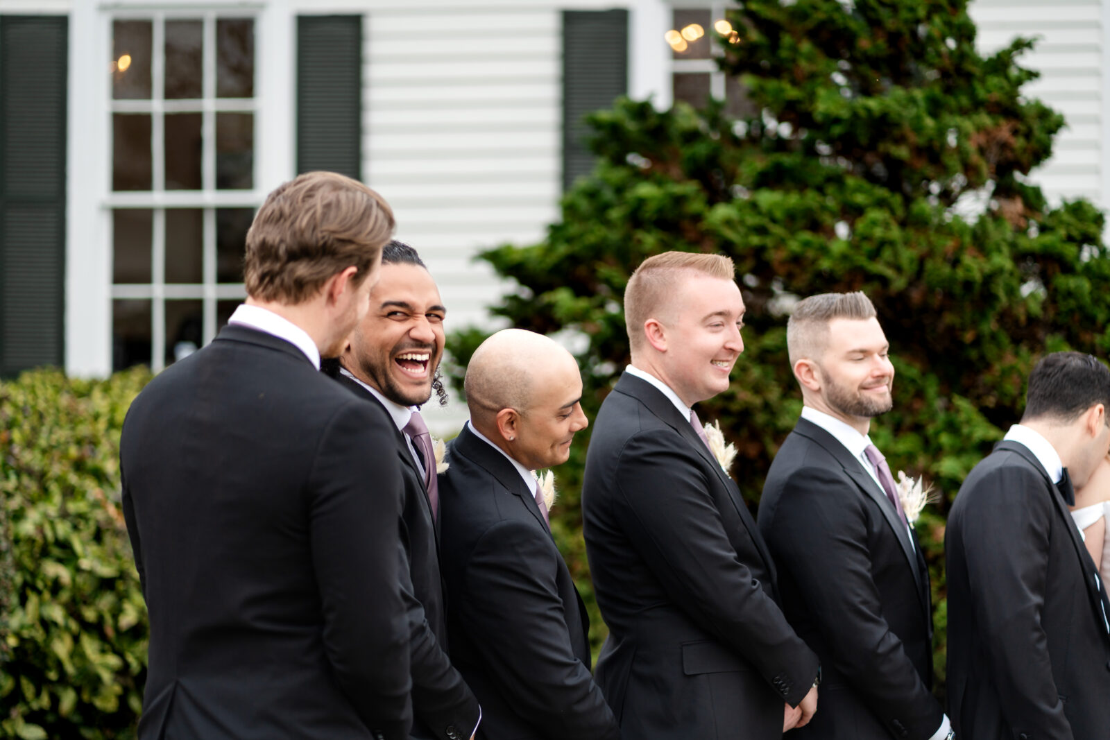 Candid moment of groomsmen laughing outside 173 Carlyle House in Norcross Georgia
