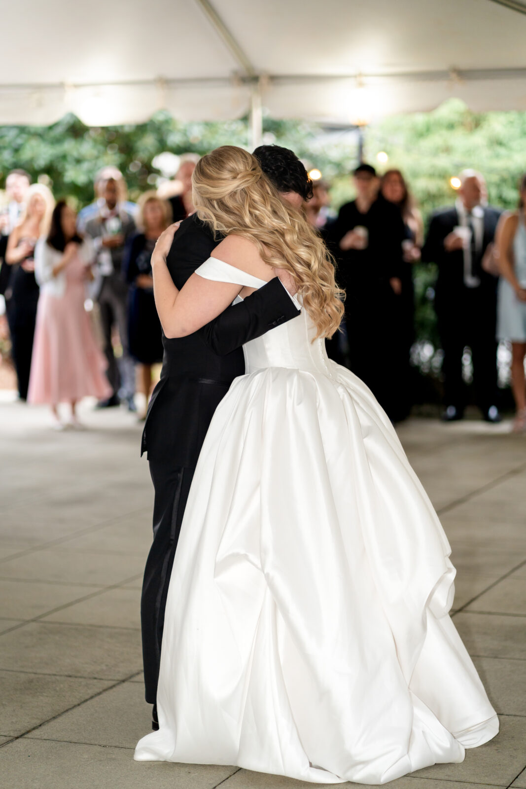Bride and groom embracing during their first dance at Carlyle House wedding reception