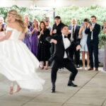Excited bride and groom make a grand entrance at 173 Carlyle House wedding in Norcross GA