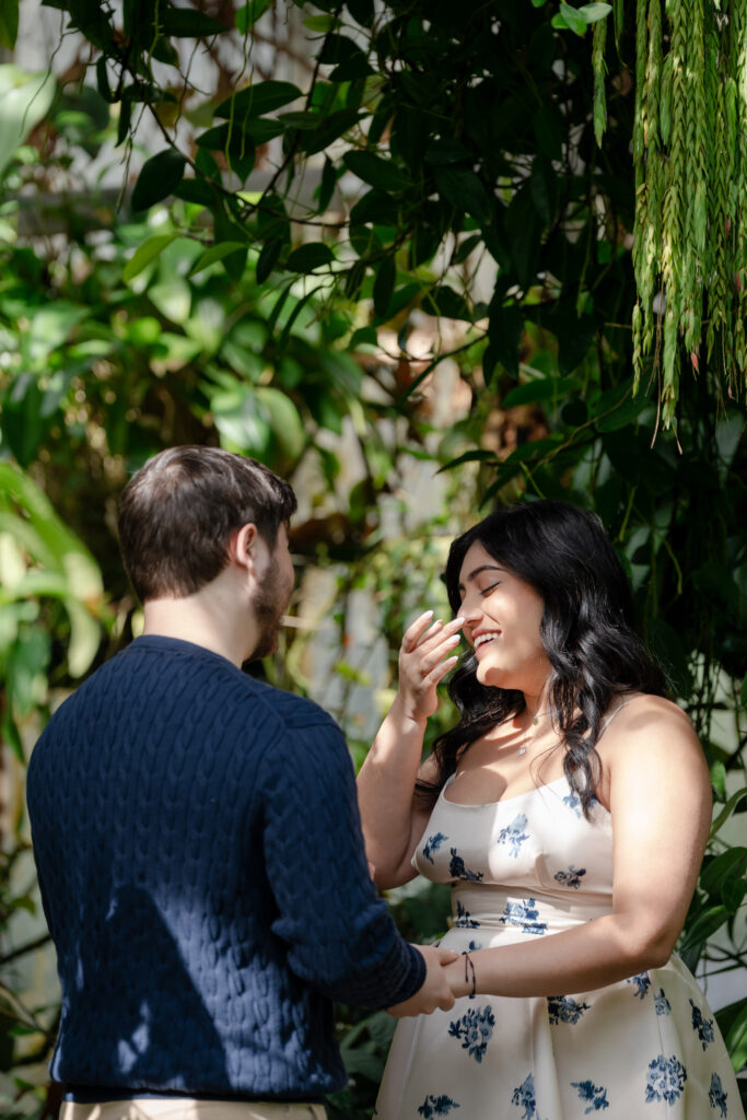 Bride wiping tears of joy after saying yes during surprise proposal