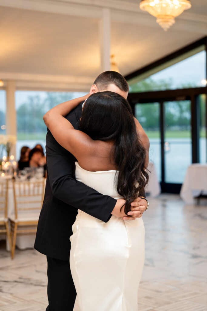 Bride and groom embracing during their first dance at Chateau 1800.
