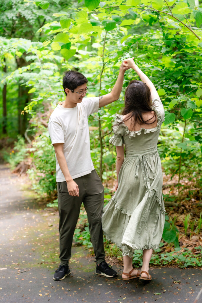 Couple dancing after surprise proposal in Atlanta at Fernbank Forest