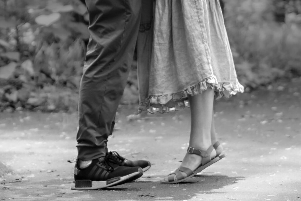 Close-up of couple’s feet after proposal, candid black and white photo