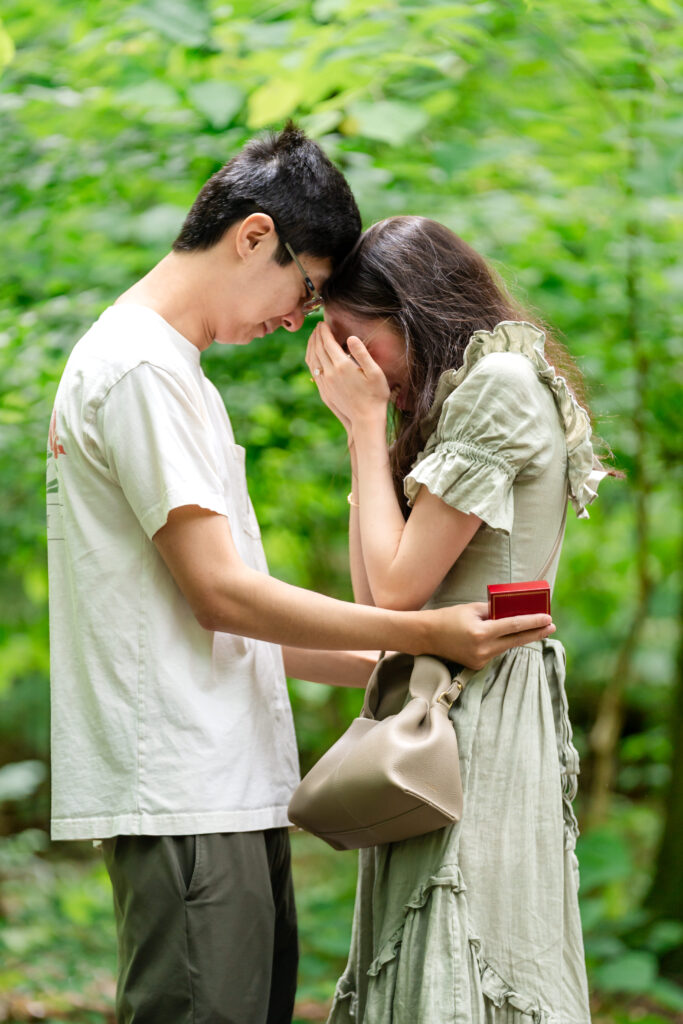 Tender moment with couple forehead to forehead after proposal