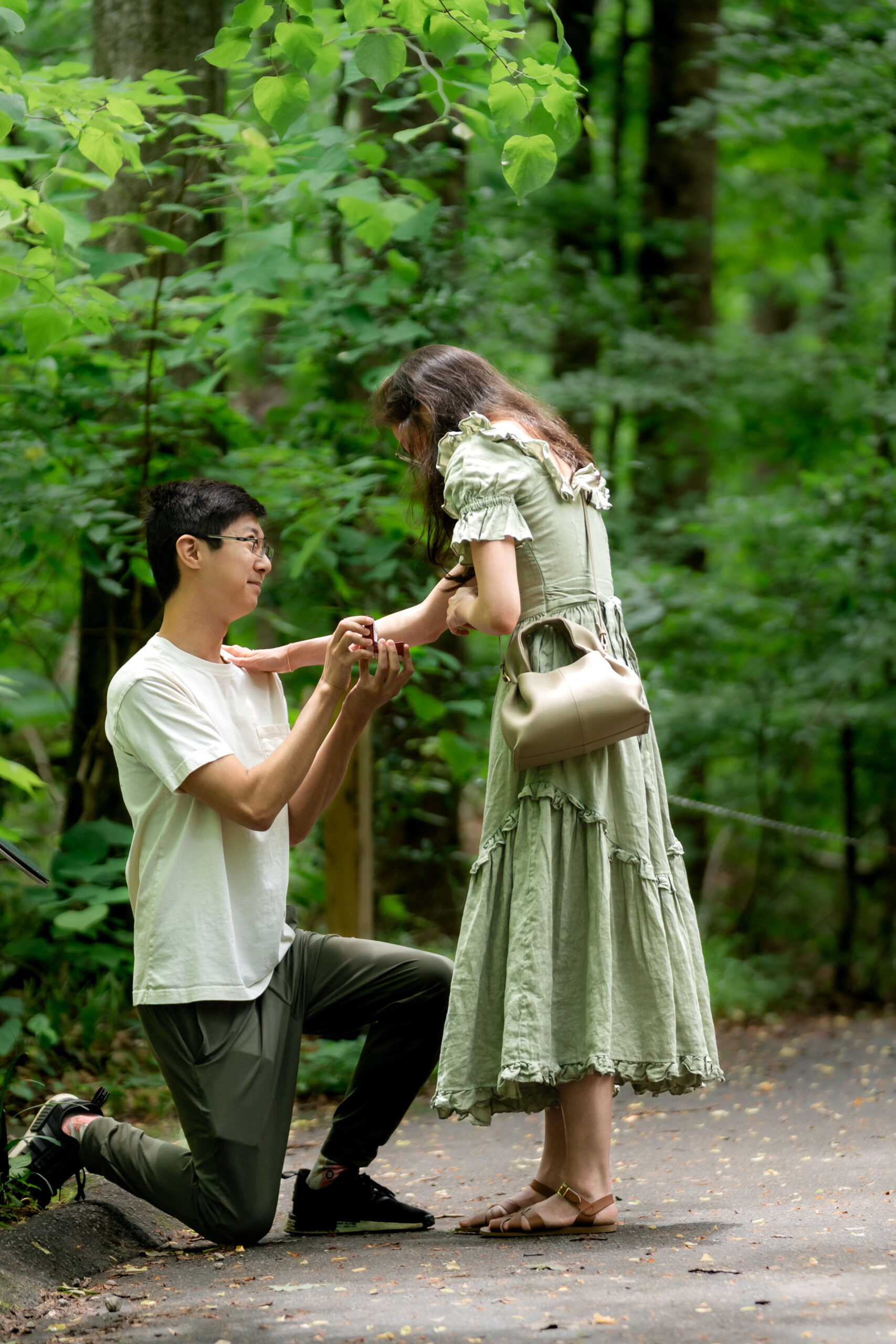 Surprise proposal in Atlanta at Fernbank Forest, groom kneeling