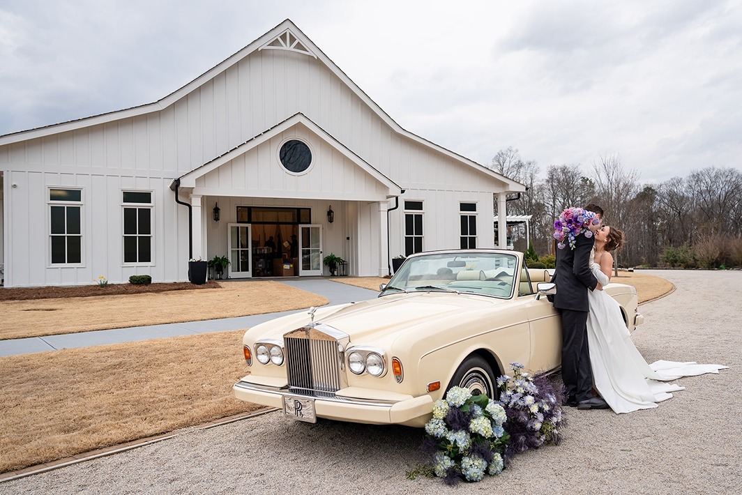 A bride and groom kissing outside of Whitestone Reserve, one of the best wedding venues in Georgia