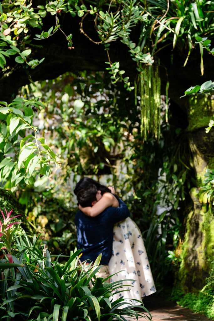 Couple embraces after proposal at the Atlanta Botanical Gardens.