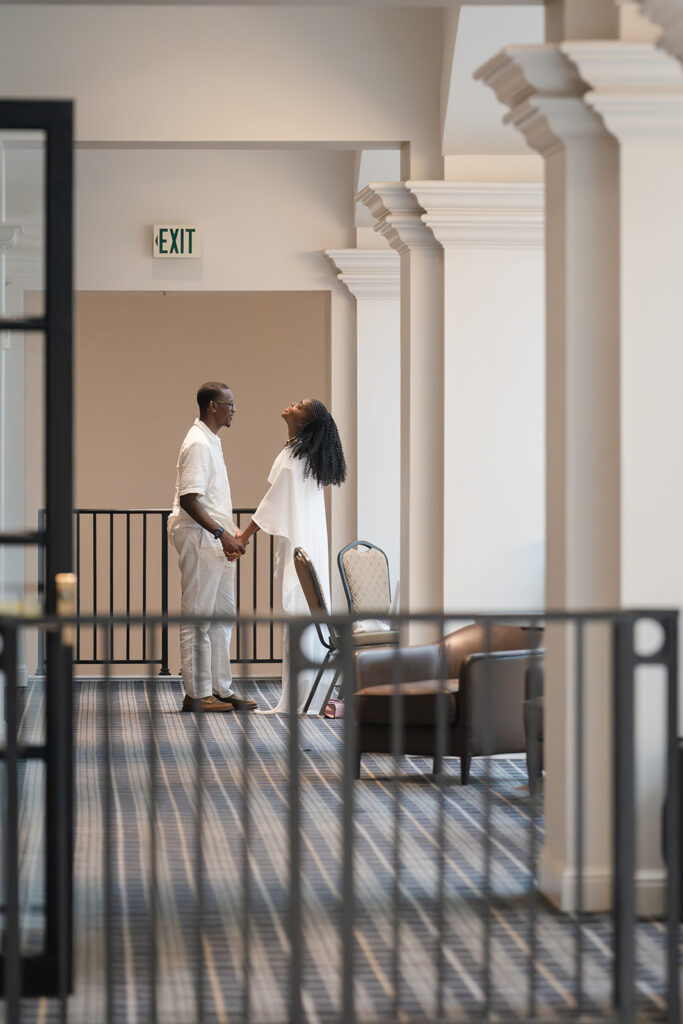 Emotional moment during winery proposal on the balcony above the Versailles Restaurant Château Élan