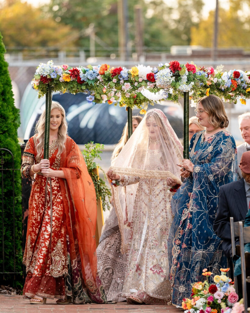 A bride walks down the aisle where an Indian wedding planner in Atlanta GA coordinated a luxury South Asian wedding weekend. 