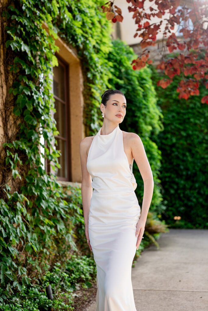 Average Wedding Cost in Georgia | Kalyn Wolf Studios Bride poses in front of beautiful gardens at a top venue in Georgia, as an example of average wedding venue cost in Georgia.