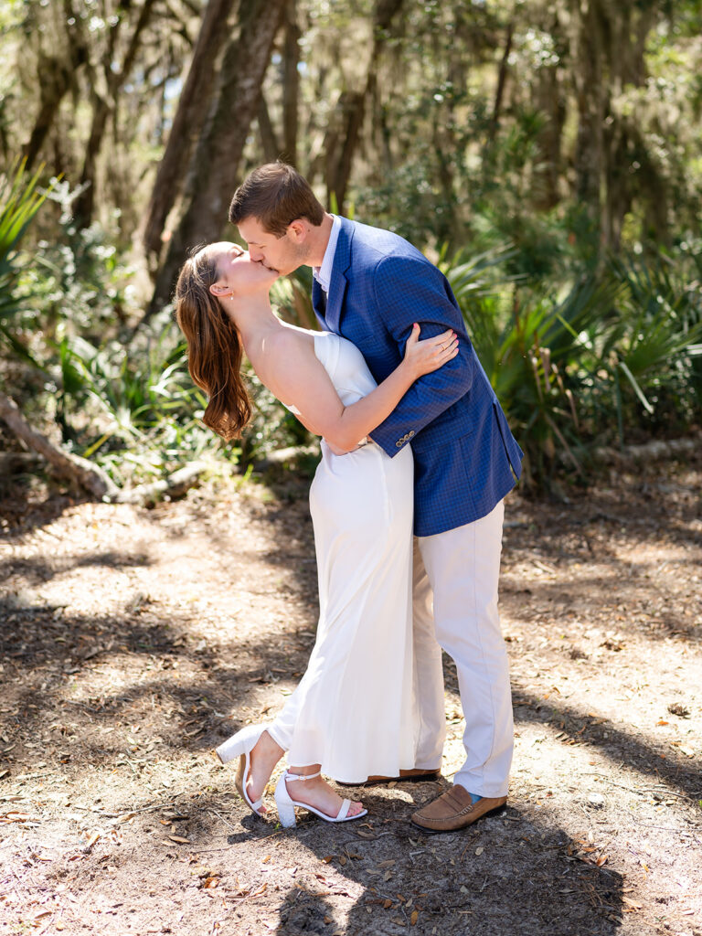 Average Wedding Cost in Georgia | Kalyn Wolf Studios Couple kissing outside among the tress, showing example of average cost of a wedding in Georgia.