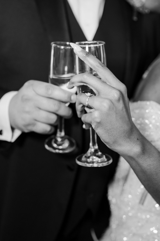 Average Wedding Cost in Georgia | Kalyn Wolf Studios Black and white photos of couple's hands and glasses as they toast in celebration, reflecting the average cost of a wedding in Georgia.