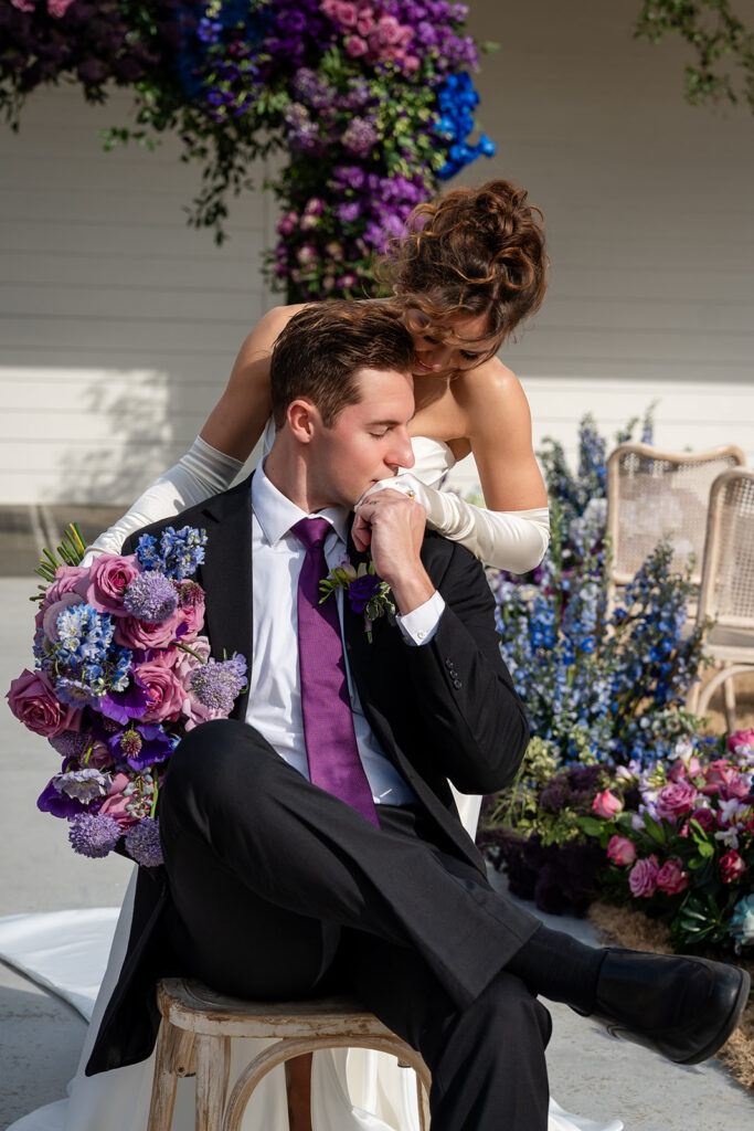 Average Wedding Cost Georgia | Kalyn Wolf Studios Groom kisses the bride's gloved hand outside a venue, representing the average wedding venue cost in Georgia.