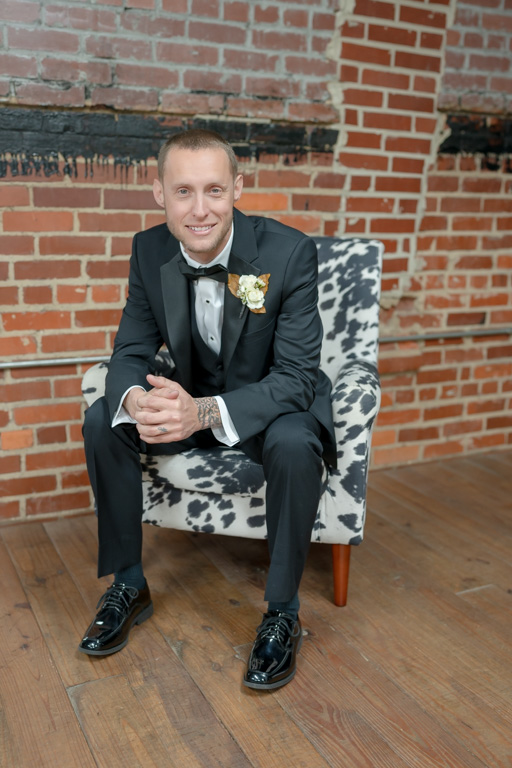 Groom sits in a chair and smiles after getting married in the state of Georgia