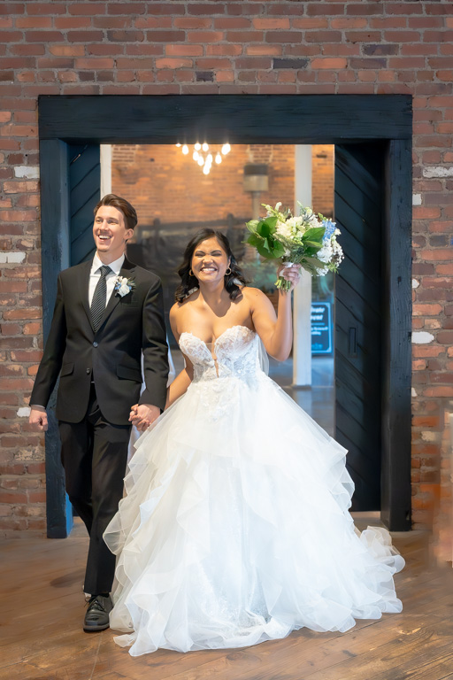 Bride and groom walk into their reception after getting married in Georgia