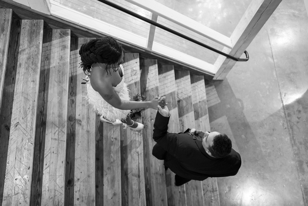 Bride and groom walk down stairs after getting married in the state of Georgia