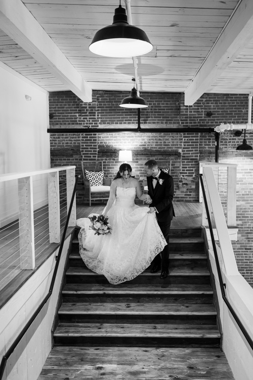 Bride and groom hold hands while walking down stairs after they get married in Georgia