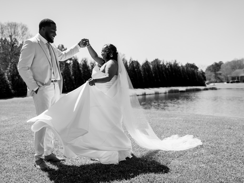 Georgia Wedding Photography | Kalyn Wolf Studios Elegant bride and groom celebrating outdoors during a Georgia wedding photography session by the lake