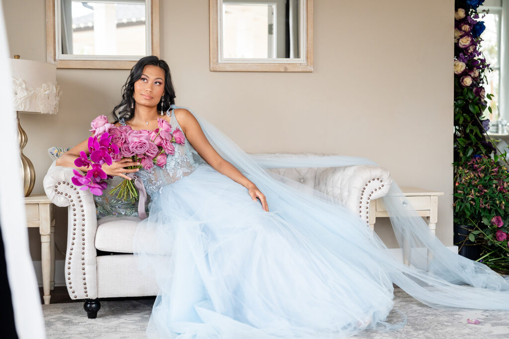 Georgia Wedding Photography Videography | Kalyn Wolf Studios Bride in a blue gown holding vibrant florals during a Georgia wedding photography and videography editorial session.
