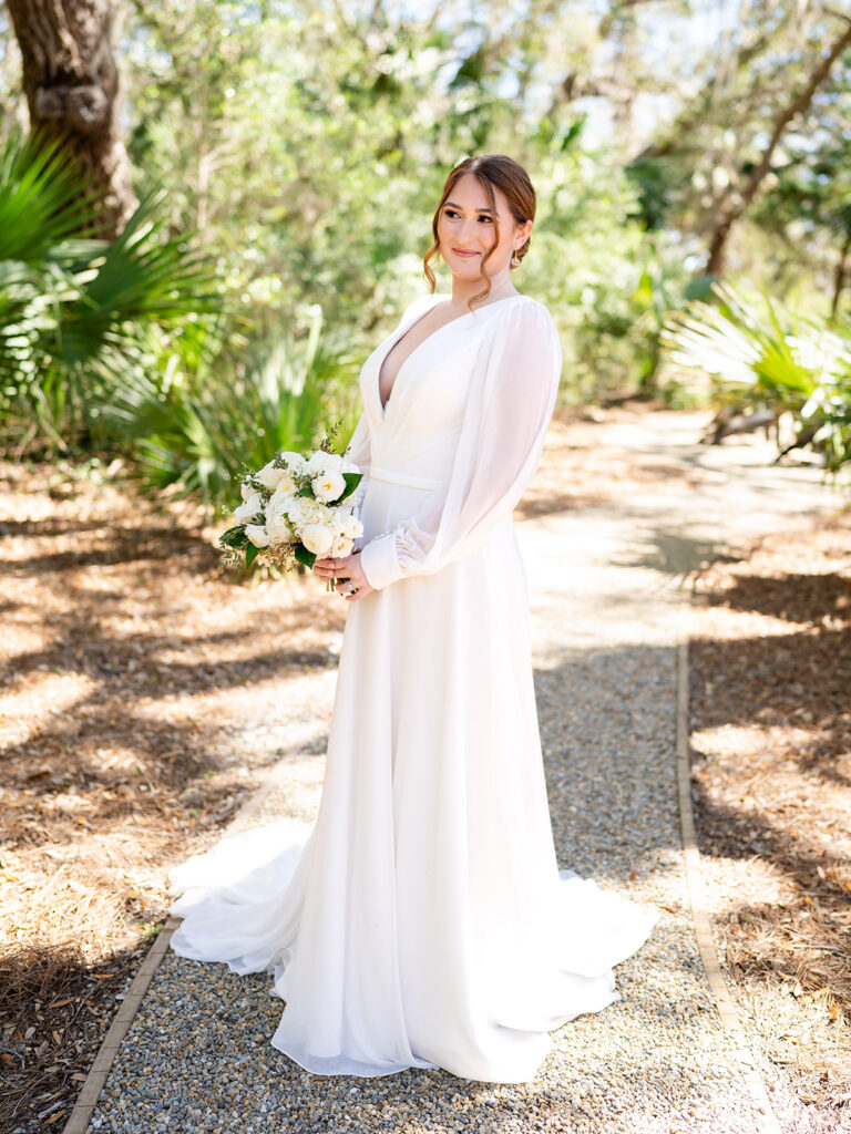 Georgia Wedding Photography | Kalyn Wolf Studios Bride holding a white bouquet during a Georgia wedding photography videography session in a garden setting.