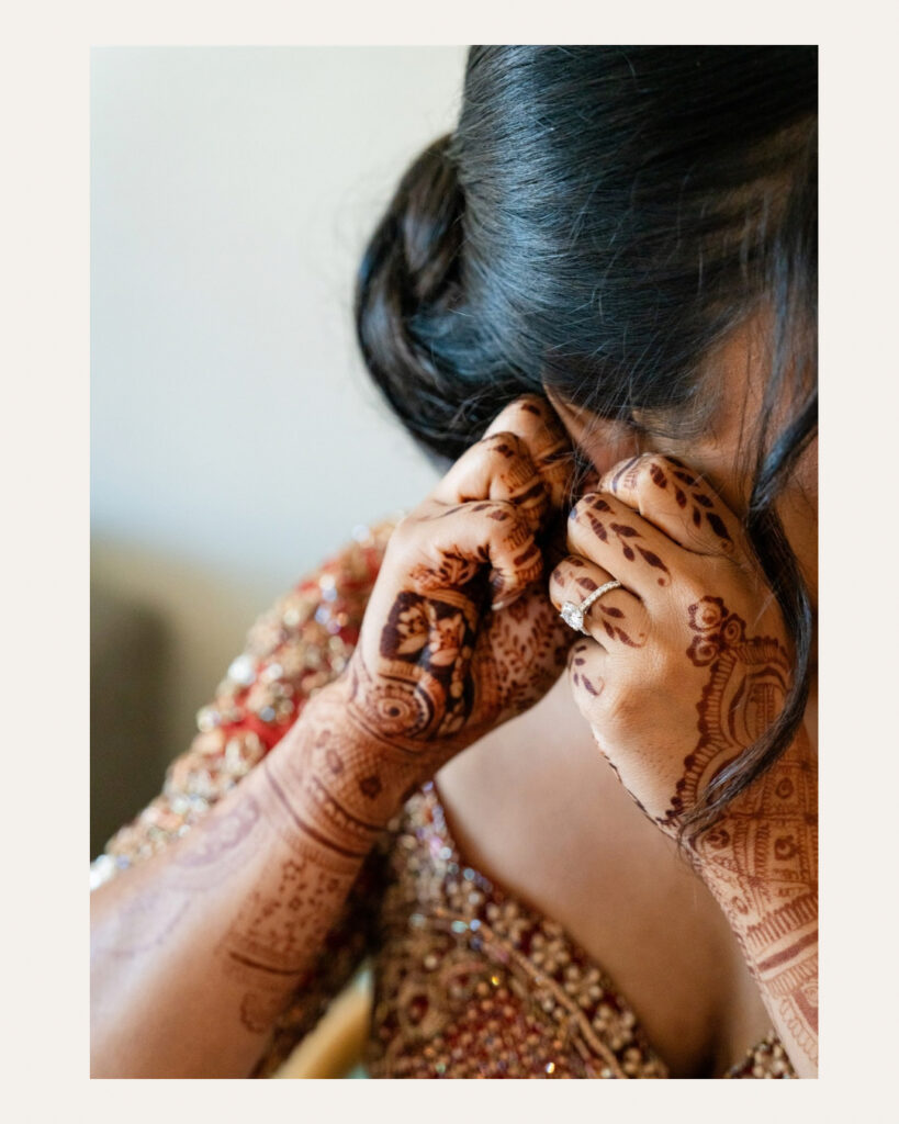 Hindu Wedding Photography in Georgia | Kalyn Wolf Studios Bride fastening her jewelry before a traditional Hindu wedding photography in Georgia celebration.