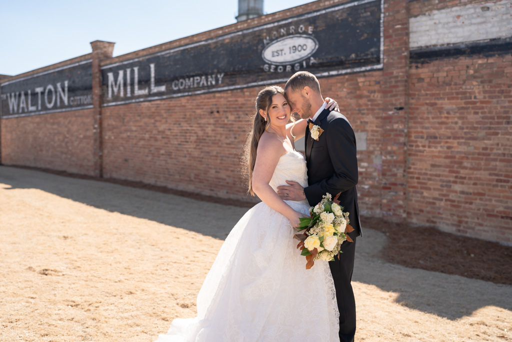Georgia Wedding Photography | Kalyn Wolf Studios Bride and groom embracing outside Walton Mill for their Georgia Wedding Photography portraits.