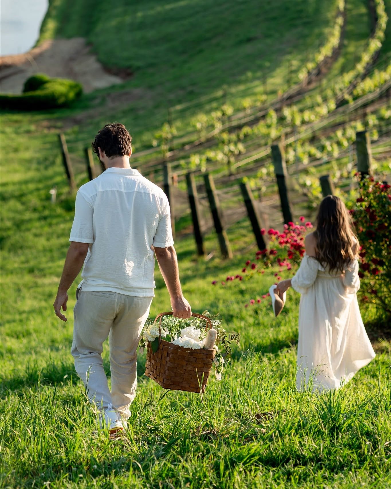 Couple walking through the vineyards at Montaluce Winery, one of the best places to take engagement photos in Georgia.