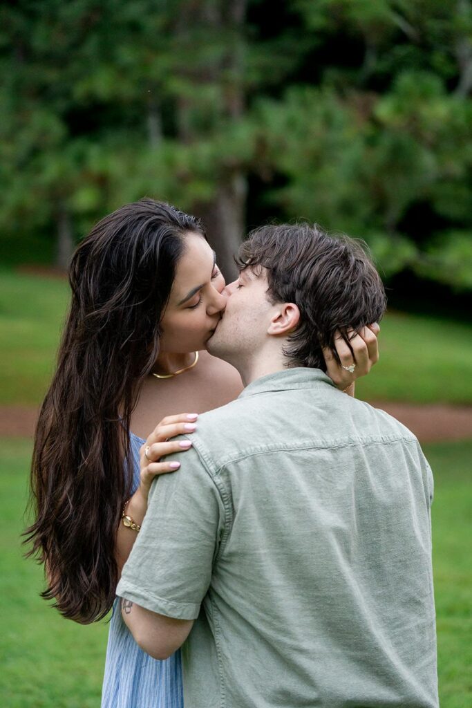 Couple sharing a kiss during an engagement session at one of the best places to take engagement photos in Georgia.