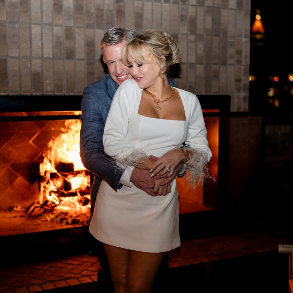 Couple cozying up by the fireplace at FORTH Hotel, one of the most romantic engagement photo locations in North Georgia.