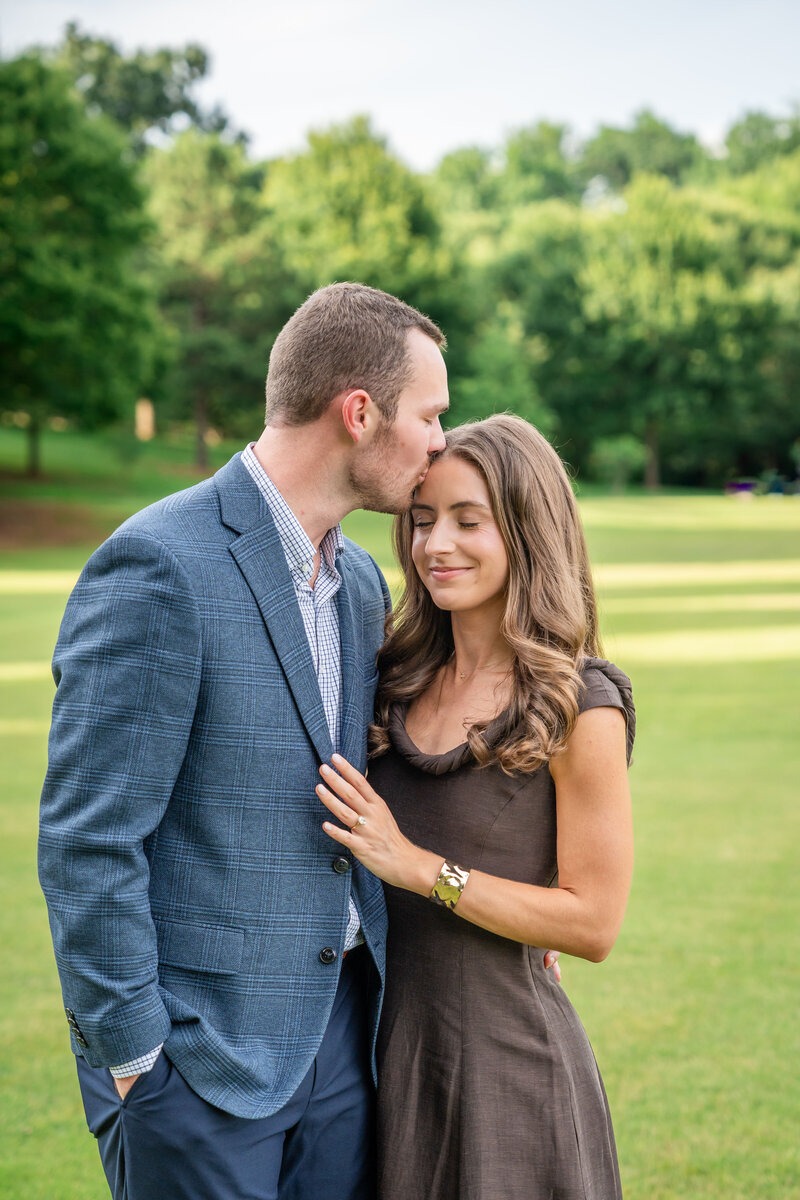 Romantic Georgia engagement photos of a couple embracing outdoors.